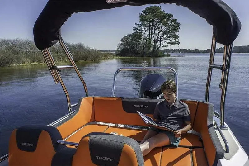 Slide: The Image of Manufacturer Provided Image: Boy reading on Zodiac Medline 6.8 boat, 2026 model. - 3