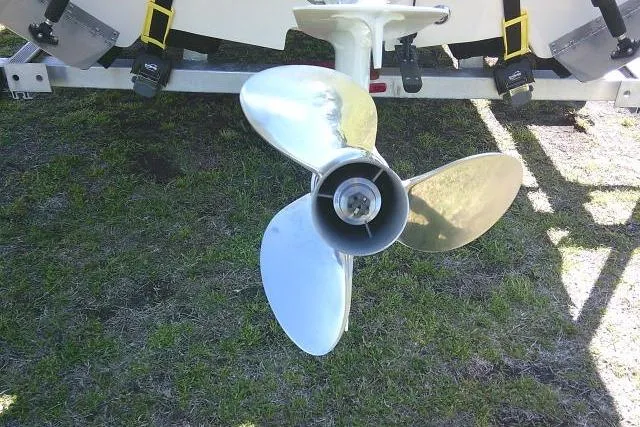 Slide: The Image of 2024 Carolina Skiff 21 LS boat propeller on grass, close-up view. - 10