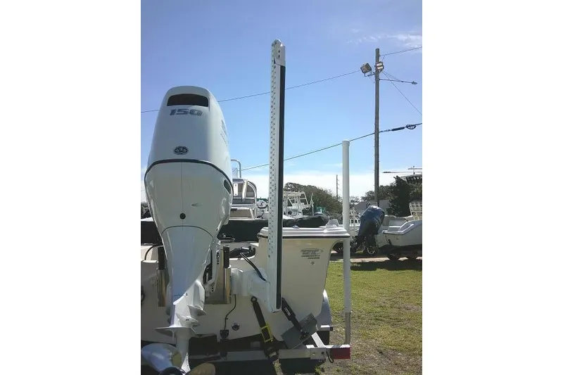 Slide: The Image of 2024 Carolina Skiff 21 LS boat with powerful outboard motor, parked outdoors. - 11