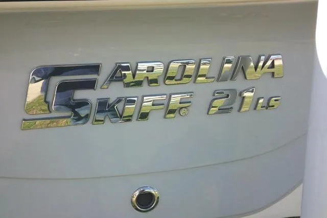Slide: The Image of 2024 Carolina Skiff 21 LS logo on boat hull, metallic lettering. - 14