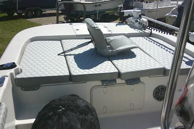 Slide: The Image of 2024 Carolina Skiff 21 LS boat with cushioned seating and storage compartments. - 16