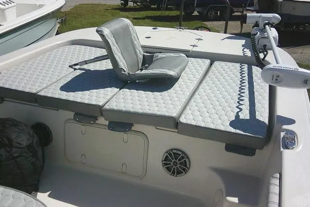 Slide: The Image of 2024 Carolina Skiff 21 LS boat interior with cushioned seating and storage compartments. - 18