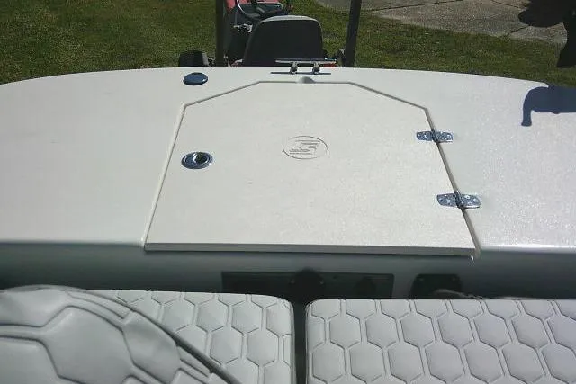 Slide: The Image of 2024 Carolina Skiff 21 LS boat deck with storage hatch and cushioned seating. - 20