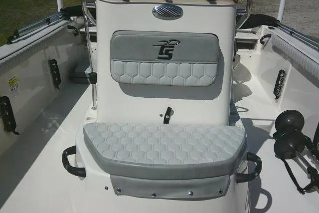 Slide: The Image of 2024 Carolina Skiff 21 LS boat interior with cushioned seating and storage. - 21