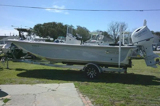 Slide: The Image of 2024 Carolina Skiff 21 LS boat on trailer with Suzuki outboard motor. - 7
