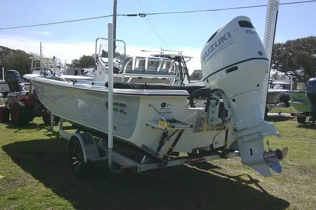 Slide: The Image of 2024 Carolina Skiff 21 LS boat with Suzuki outboard motor on trailer. - 8