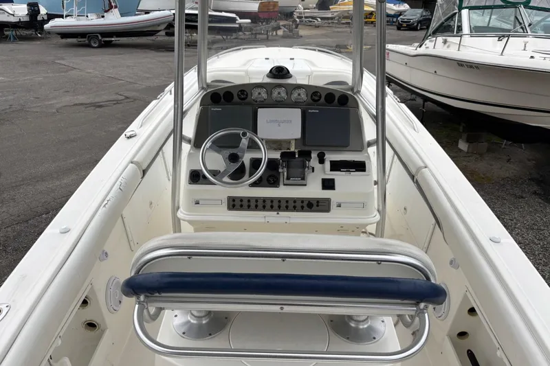 Slide: The Image of 1999 Wellcraft 302 Scarab Sport boat dashboard with steering wheel and controls. - 4