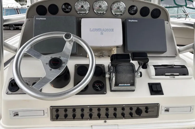Slide: The Image of Control panel of a 1999 Wellcraft 302 Scarab Sport boat with steering wheel and gauges. - 5