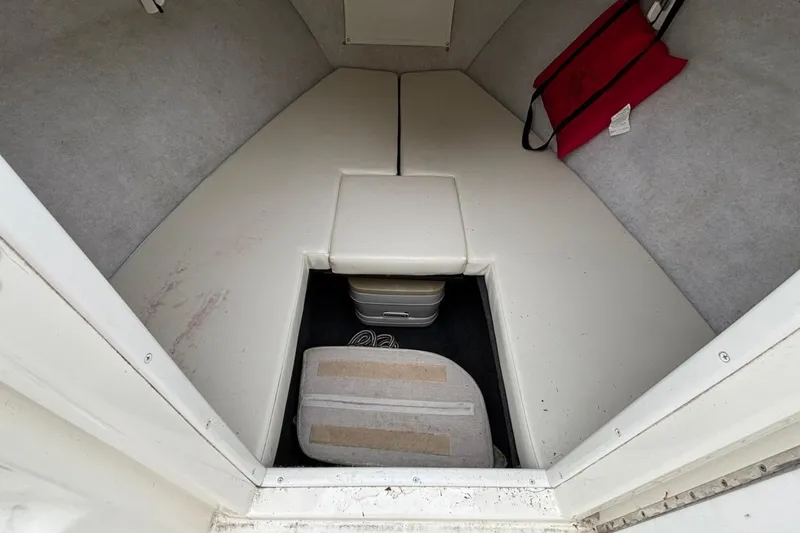 Slide: The Image of Interior cabin of 1999 Wellcraft 302 Scarab Sport boat with storage and seating. - 7