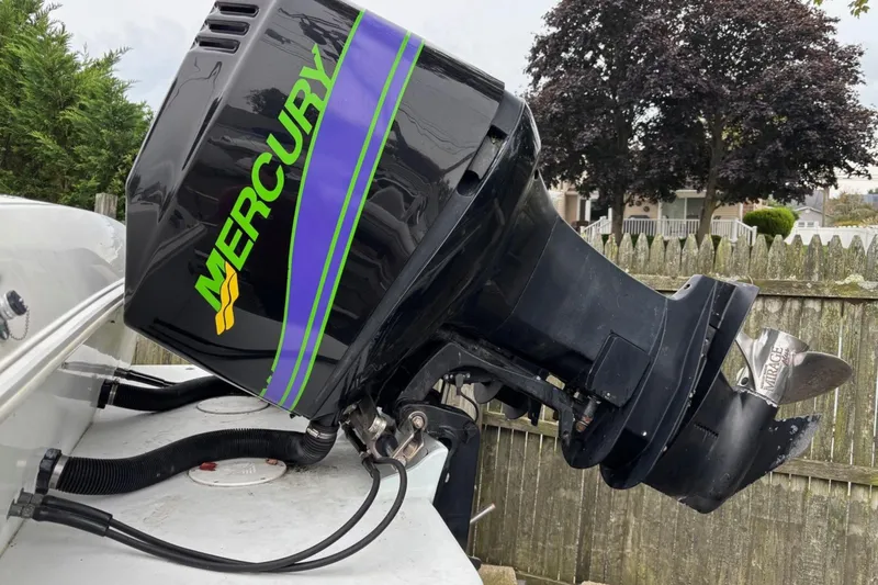Slide: The Image of Mercury outboard motor on 1999 Wellcraft 302 Scarab Sport boat, side view. - 8