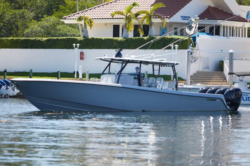 Slide: The Image of 2022 Contender 44 ST boat docked near a waterfront home. - 11