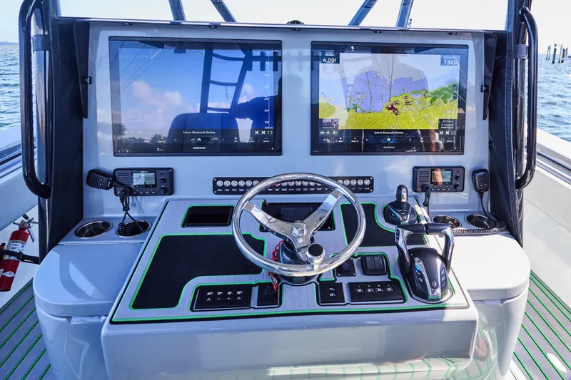 Slide: The Image of 2022 Contender 44 ST boat interior with open storage compartment, on a sunny day at sea. - 13