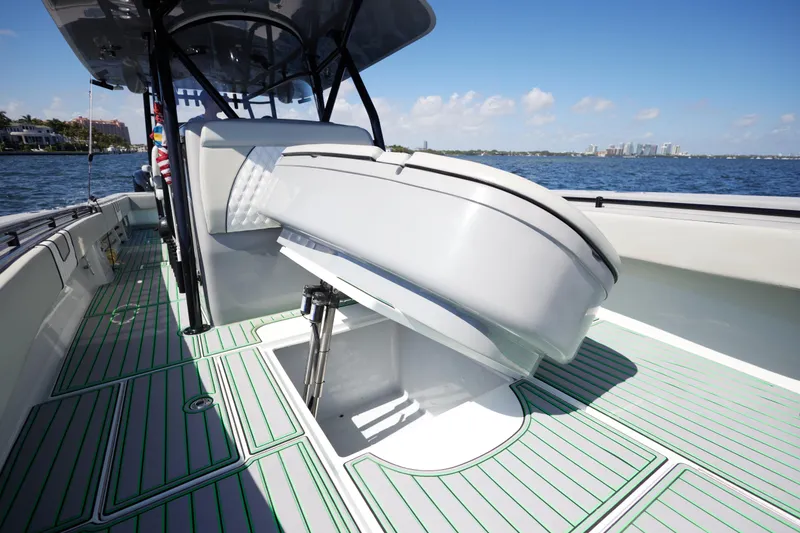 Slide: The Image of 2022 Contender 44 ST boat interior with open storage compartment and cushioned seating. - 14