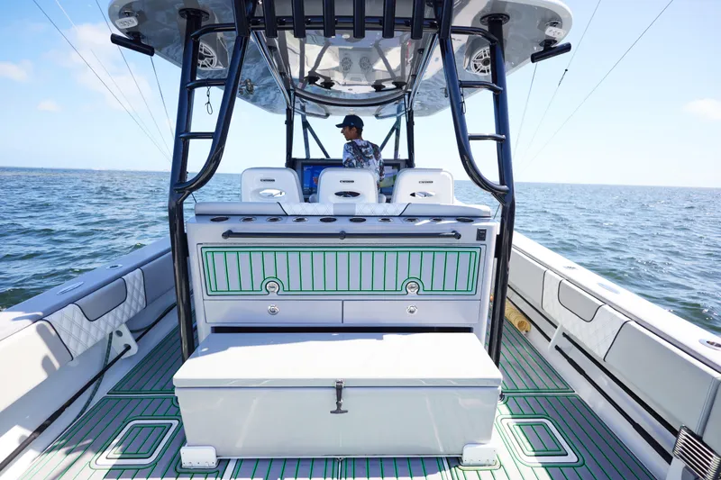 Slide: The Image of 2022 Contender 44 ST boat cruising on a scenic waterway with lush greenery. - 16