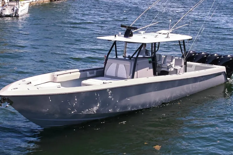 Slide: The Image of 2022 Contender 44 ST boat with multiple outboard engines on the water. - 2