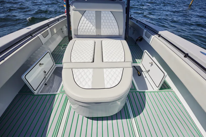Slide: The Image of 2022 Contender 44 ST boat interior with cushioned seating and open storage compartments. - 21