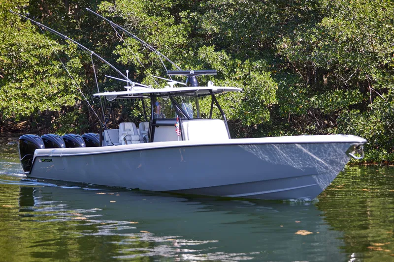 Slide: The Image of 2022 Contender 44 ST boat on water, featuring sleek design and multiple outboard engines. - 3