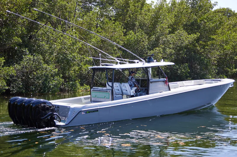 Slide: The Image of 2022 Contender 44 ST boat with four powerful outboard engines on the water. - 4