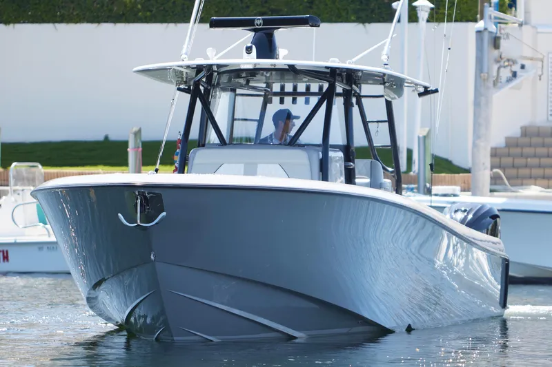 Slide: The Image of 2022 Contender 44 ST boat cruising on a calm waterway, surrounded by lush greenery. - 7