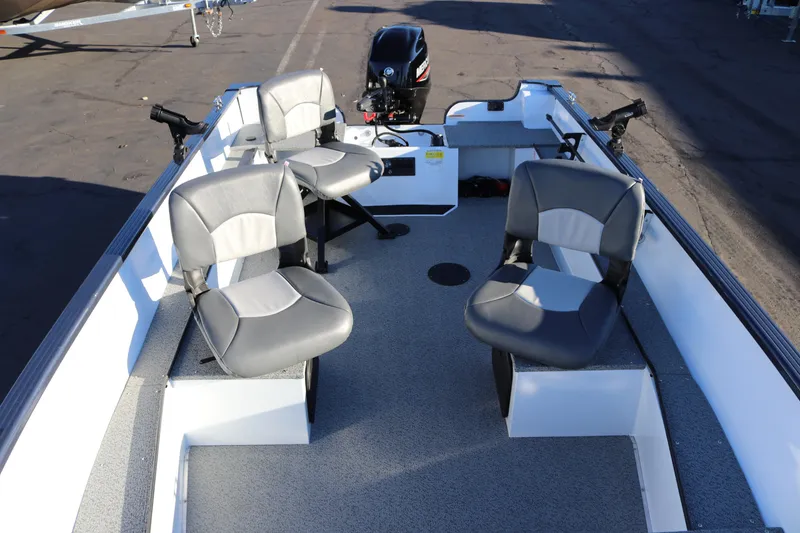 Slide: The Image of 2026 Smoker Craft Pro Lodge 160 boat interior with four seats and motor. - 12