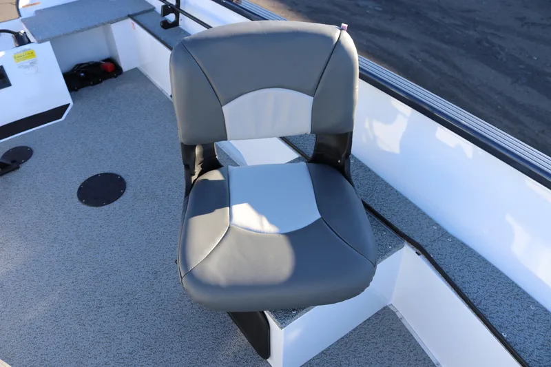 Slide: The Image of 2026 Smoker Craft Pro Lodge 160 boat seat, gray and white upholstery, on deck. - 15