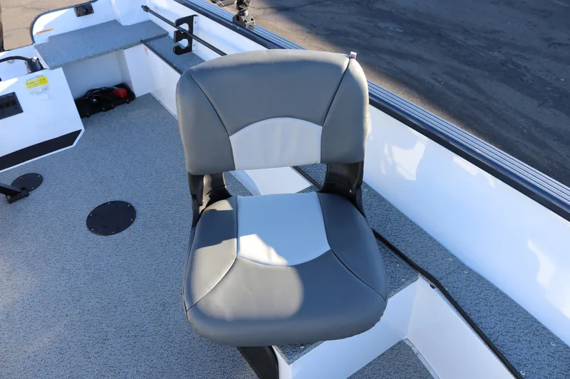 Slide: The Image of 2026 Smoker Craft Pro Lodge 160 boat seat, gray and white design, on deck. - 16