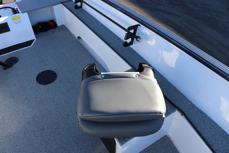 Slide: The Image of 2026 Smoker Craft Pro Lodge 160 boat interior with seating and storage compartments. - 17