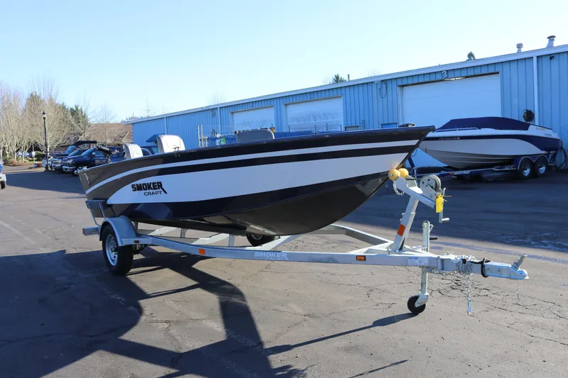 Slide: The Image of 2026 Smoker Craft Pro Lodge 160 boat on trailer in outdoor setting. - 7