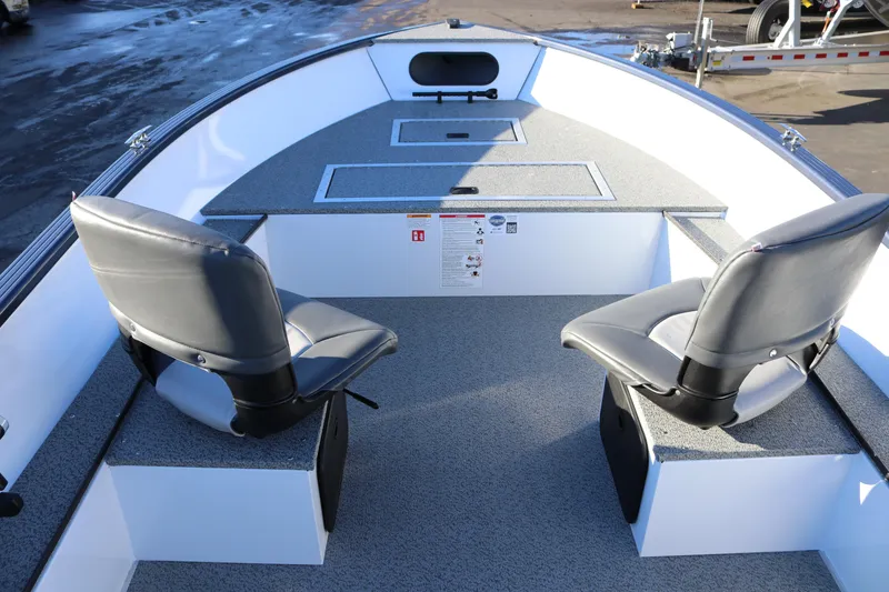 Slide: The Image of 2026 Smoker Craft Pro Lodge 160 interior with two gray seats and storage compartments. - 8