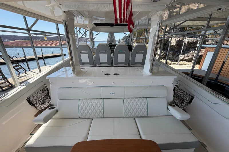 Slide: The Image of 2023 Regal 38 SAV boat interior with grill, sink, and wooden table. - 33