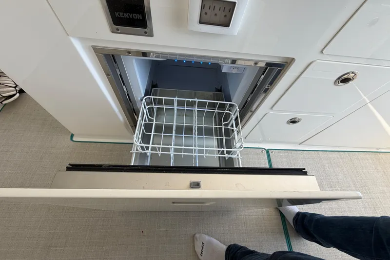 Slide: The Image of 2023 Regal 38 SAV boat dashboard with steering wheel and navigation displays. - 34