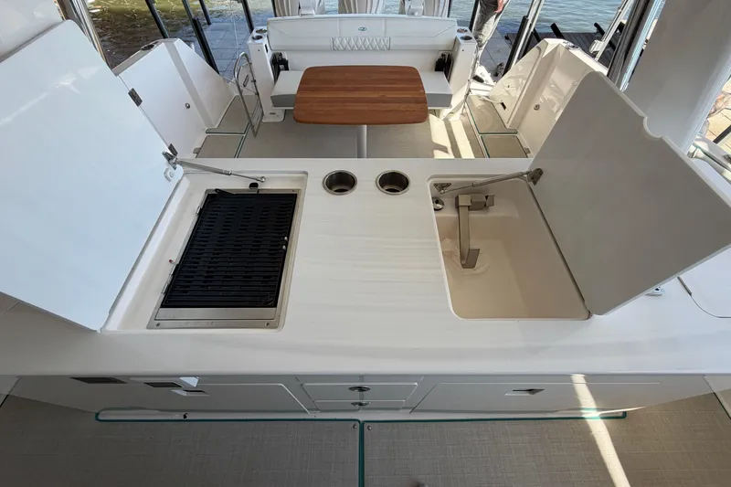 Slide: The Image of 2023 Regal 38 SAV boat cockpit with modern controls and scenic water view. - 35