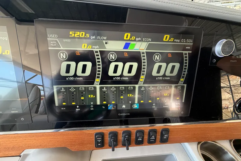 Slide: The Image of Control panel of 2023 Regal 38 SAV boat with modern throttle levers. - 40