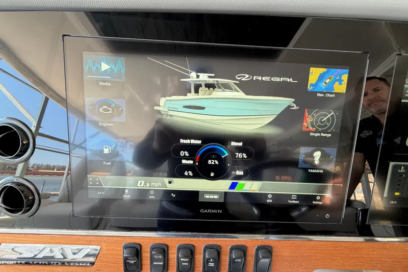 Slide: The Image of Control panel of 2023 Regal 38 SAV boat with joystick and trim tab controls. - 41