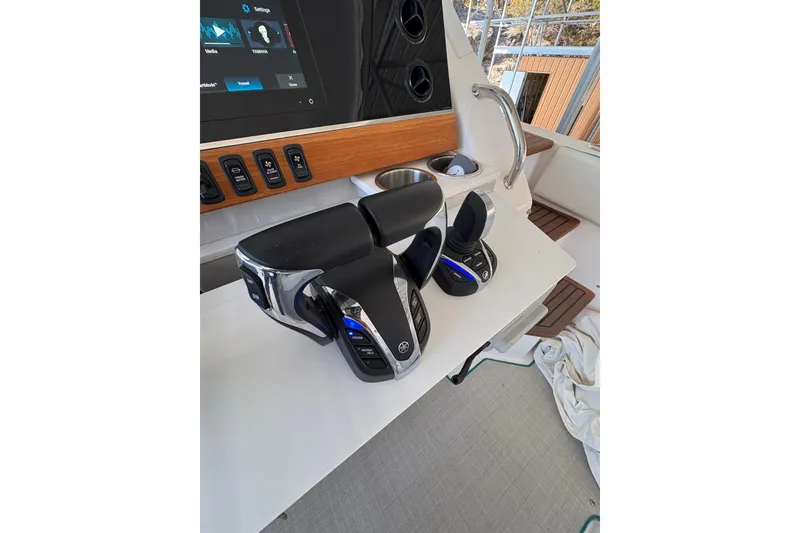 Slide: The Image of 2023 Regal 38 SAV boat helm with modern controls and navigation screens. - 42