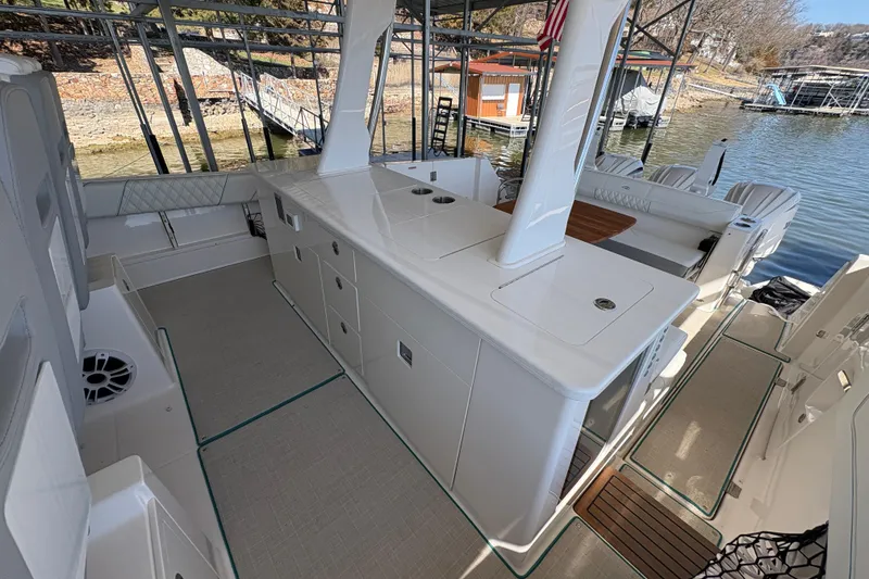 Slide: The Image of 2023 Regal 38 SAV boat interior with control panel and storage compartment. - 47