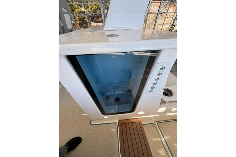 Slide: The Image of 2023 Regal 38 SAV boat interior with white seating and wooden table. - 49