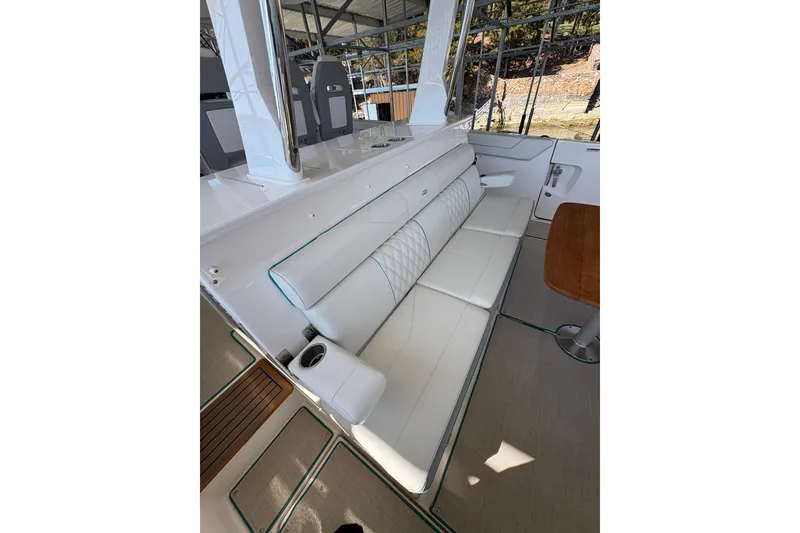 Slide: The Image of 2023 Regal 38 SAV luxury boat docked, featuring spacious seating and modern design. - 51