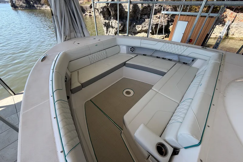 Slide: The Image of 2023 Regal 38 SAV yacht docked under a covered marina with scenic lake view. - 52