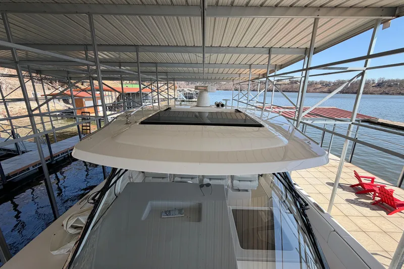 Slide: The Image of 2023 Regal 38 SAV boat with open engine compartment at dockside, Sunrise Beach, MO. - 54