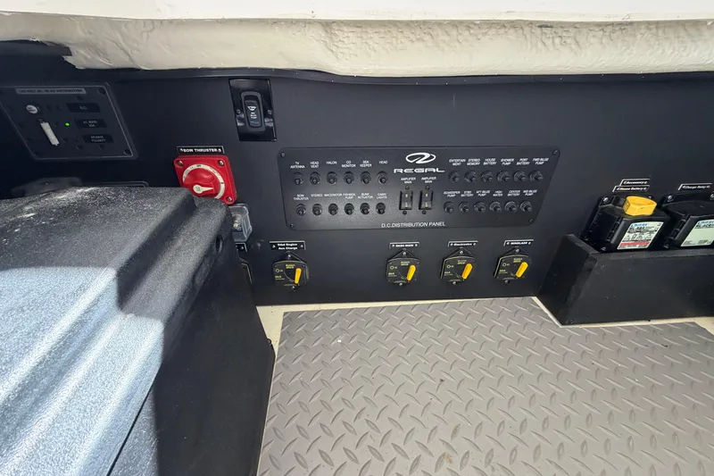 Slide: The Image of Control panel of 2023 Regal 38 SAV boat with various switches and indicators. - 57