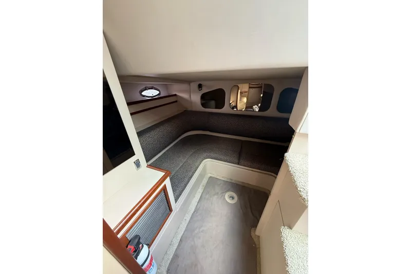 Slide: The Image of 2001 Cruisers Yachts 3470 Express cabin interior with seating and porthole window. - 11