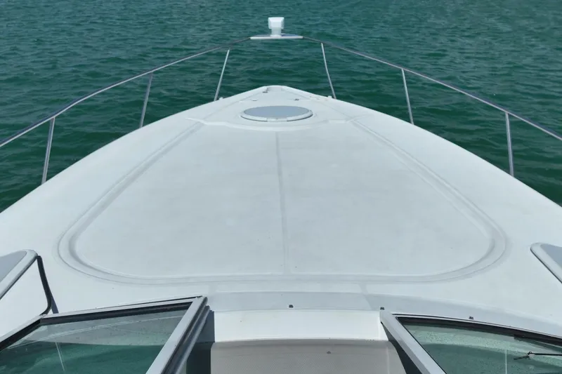 Slide: The Image of Bow view of 2001 Cruisers Yachts 3470 Express on open water. - 4