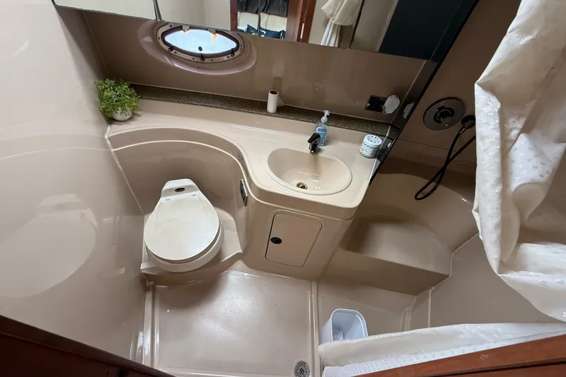 Slide: The Image of 2001 Cruisers Yachts 3470 Express bathroom with toilet, sink, and shower. - 8