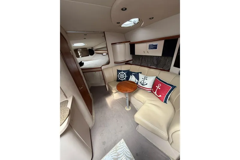Slide: The Image of Interior of 2001 Cruisers Yachts 3470 Express with nautical-themed cushions and cozy seating. - 9