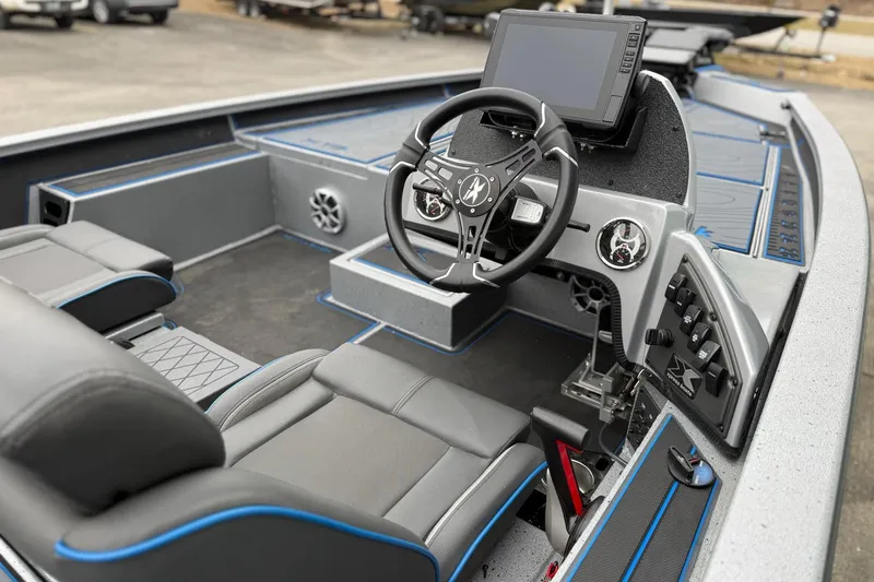 Slide: The Image of Interior of 2026 Xpress X19 Pro boat with modern steering and control panel. - 10