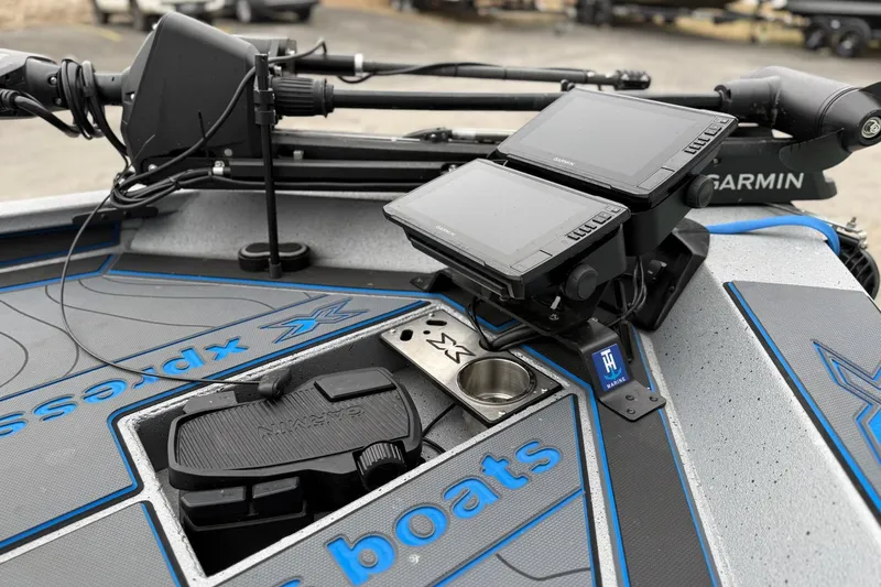 Slide: The Image of 2026 Xpress X19 Pro boat dashboard with dual Garmin displays and advanced controls. - 11