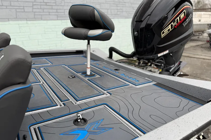 Slide: The Image of 2026 Xpress X19 Pro boat deck with seating and powerful outboard motor. - 7