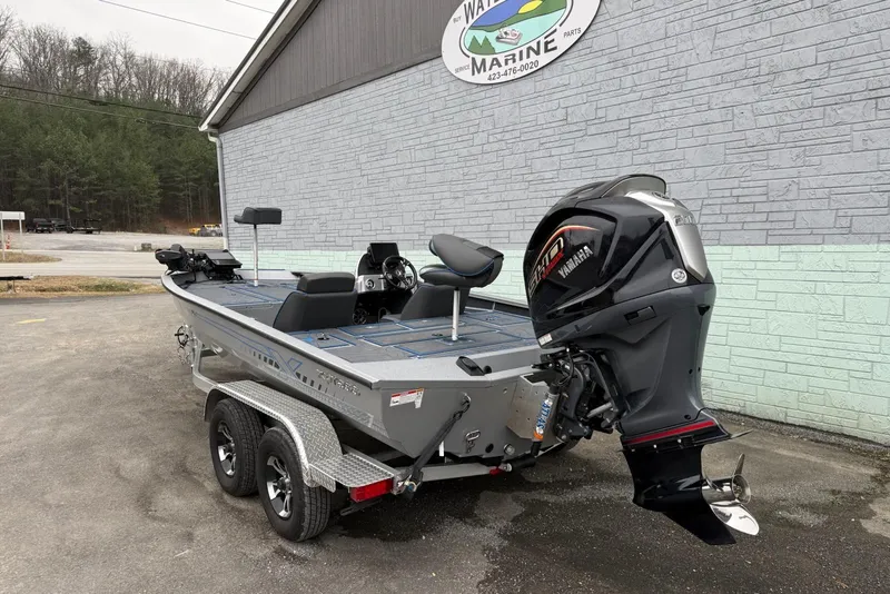 Slide: The Image of 2026 Xpress X19 Pro boat with Yamaha engine, parked outside a marine service center. - 8