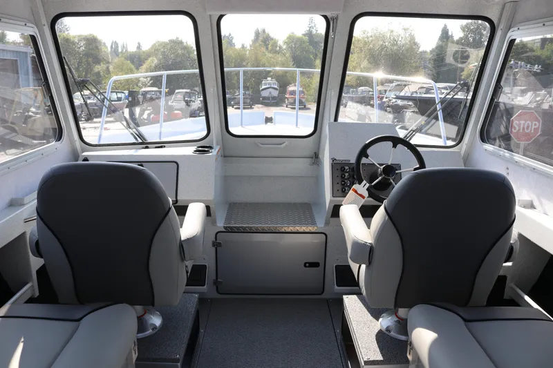 Slide: The Image of Interior of 2026 KingFisher 2425 Escape HT boat, featuring dual seats and steering console. - 15